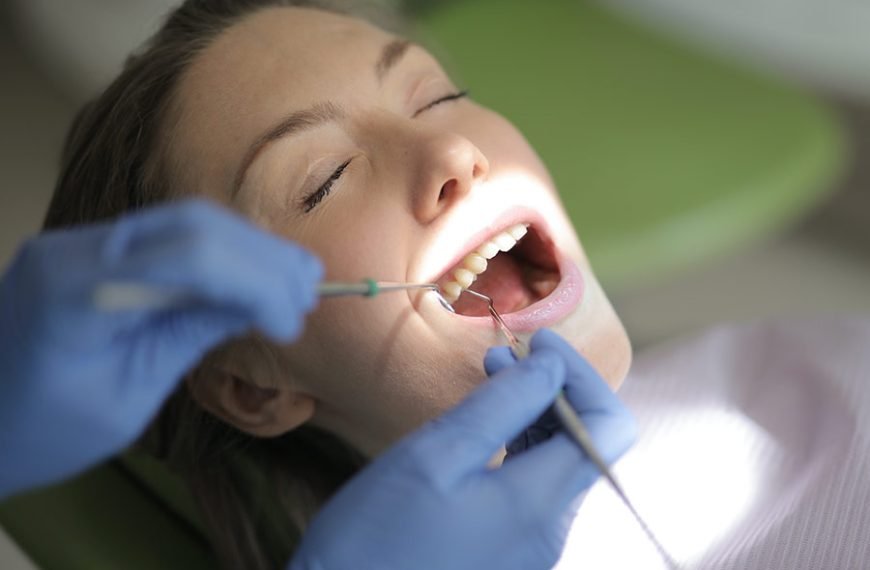 Dentista revisa el implante dental de una paciente y parece que está todo correcto.